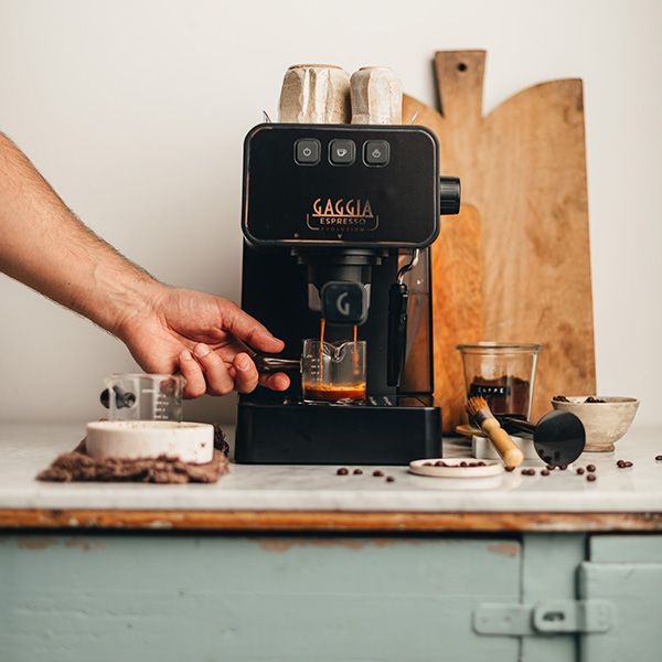 gaggia coffee machine on kitchen bench with cutting board behind