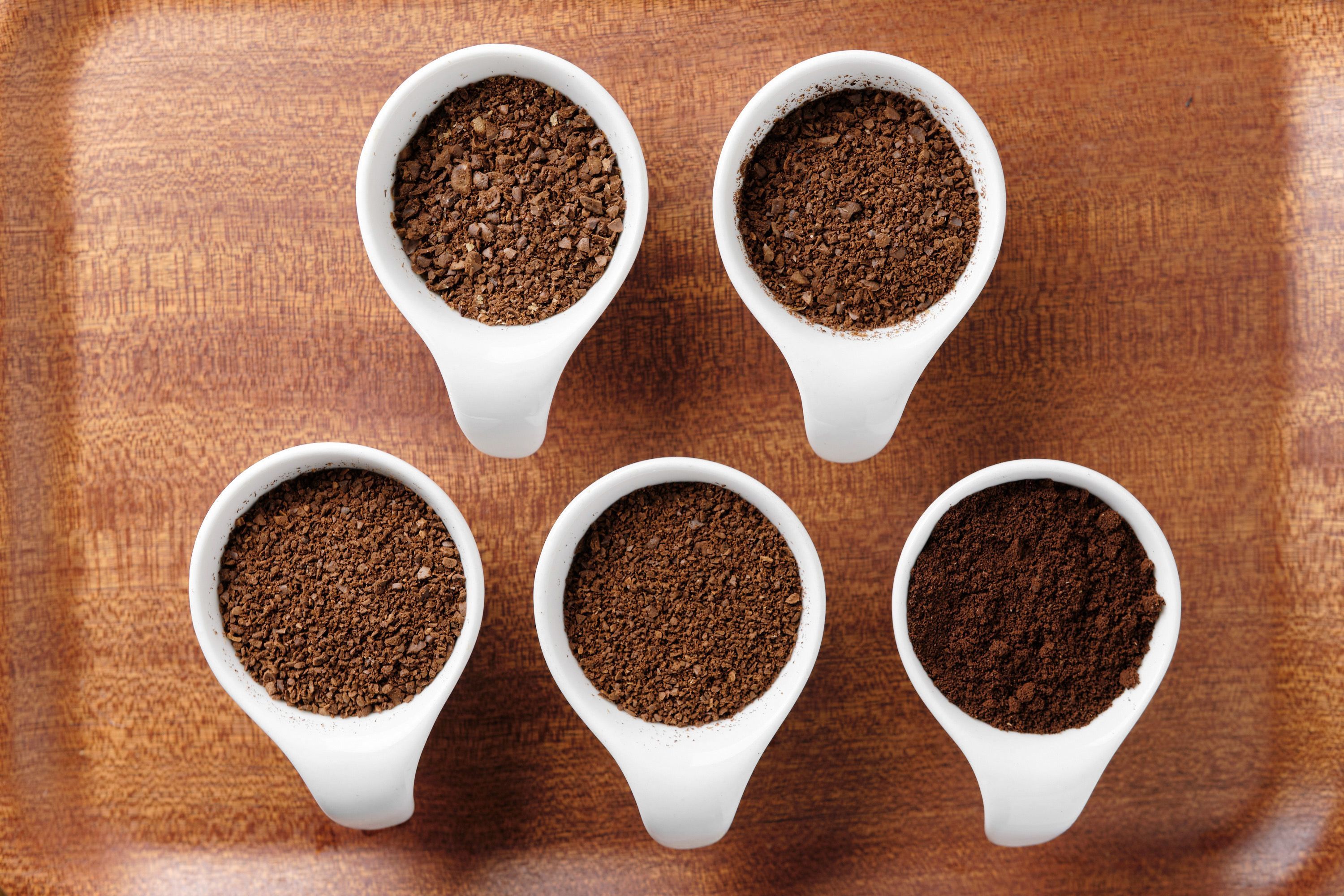 5 cups with various grinds of coffee